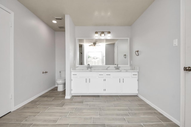 4310 Lucas Trace Ct, Houston, TX 77066 - full bath with double vanity, toilet, ceiling fan, wood finish floors, and recessed lighting
