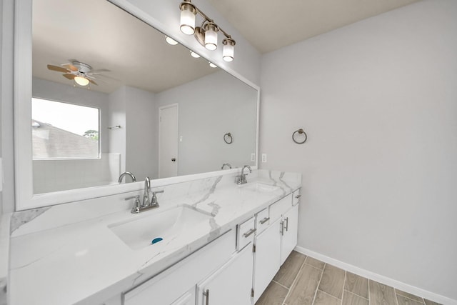 4310 Lucas Trace Ct, Houston, TX 77066 - bathroom featuring double vanity, ceiling fan, baseboards, and wood finish floors