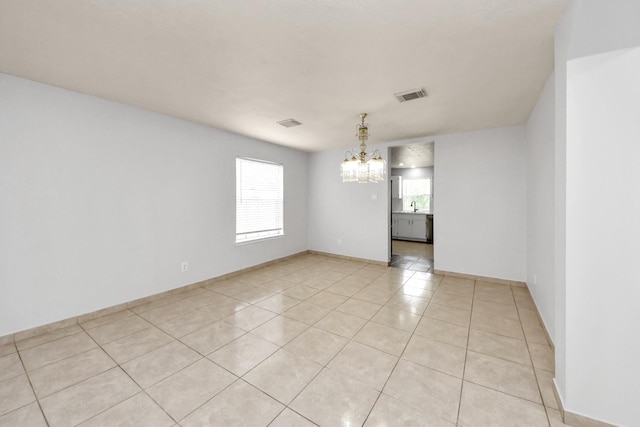 4310 Lucas Trace Ct, Houston, TX 77066 - unfurnished room with a chandelier, light tile patterned flooring, baseboards, and a sink
