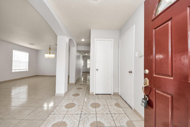 4310 Lucas Trace Ct, Houston, TX 77066 - foyer with a chandelier, light tile patterned flooring, arched walkways, baseboards, and recessed lighting