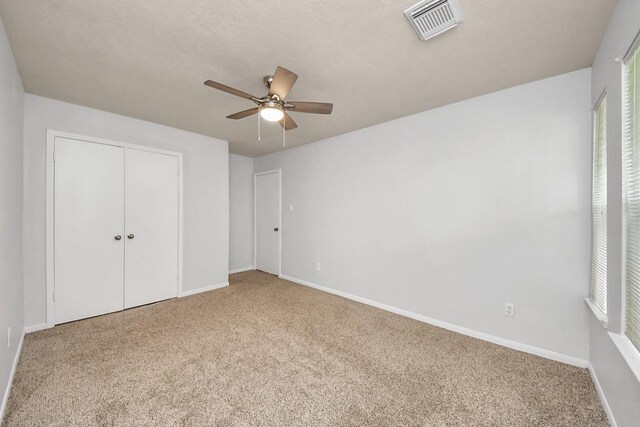 4310 Lucas Trace Ct, Houston, TX 77066 - unfurnished bedroom featuring carpet flooring, a closet, baseboards, and a ceiling fan