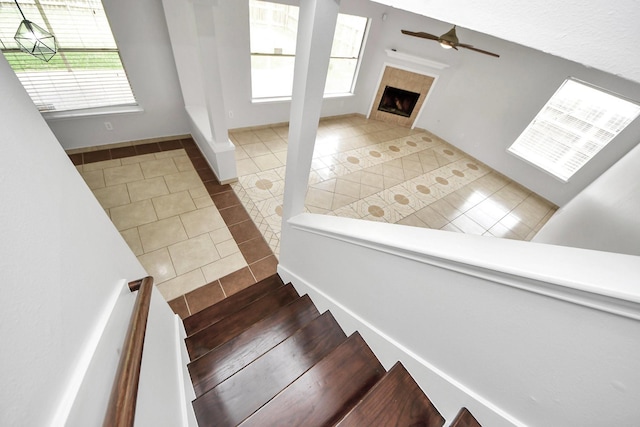 4310 Lucas Trace Ct, Houston, TX 77066 - stairway featuring tile patterned floors, ceiling fan, and a tile fireplace