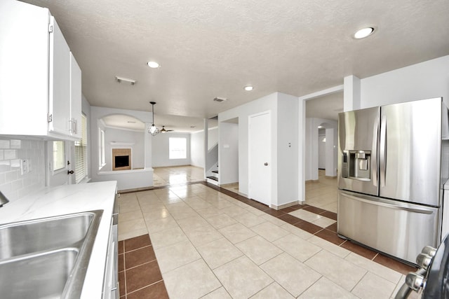 4310 Lucas Trace Ct, Houston, TX 77066 - kitchen with stainless steel refrigerator with ice dispenser, a sink, light tile patterned floors, open floor plan, and white cabinets