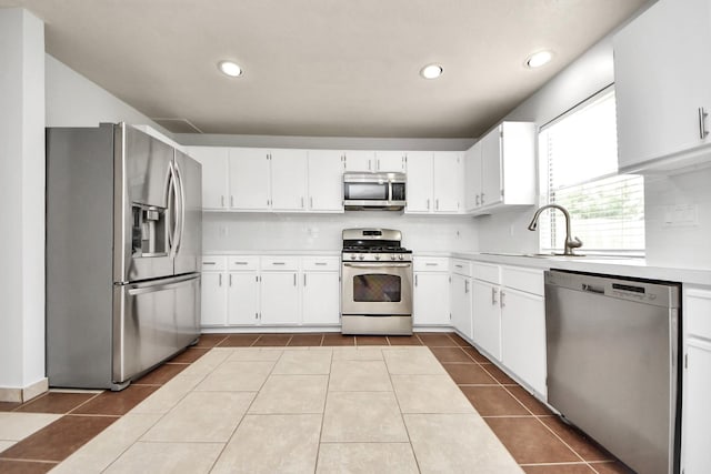 4310 Lucas Trace Ct, Houston, TX 77066 - kitchen featuring appliances with stainless steel finishes, light countertops, decorative backsplash, a sink, and dark tile patterned flooring