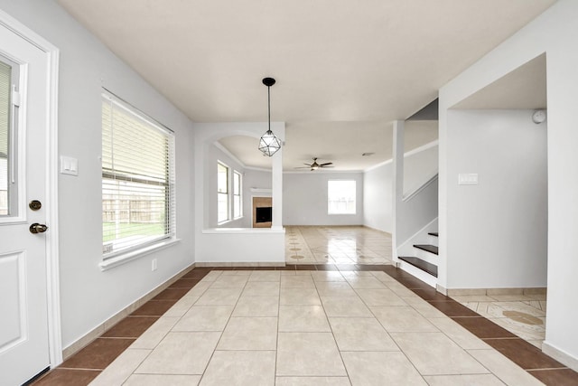 4310 Lucas Trace Ct, Houston, TX 77066 - unfurnished dining area featuring tile patterned floors, ceiling fan, stairs, and a fireplace
