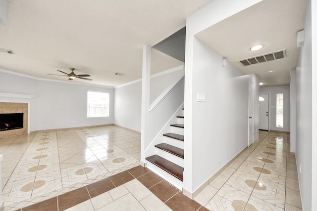 4310 Lucas Trace Ct, Houston, TX 77066 - stairs with tile patterned floors, ceiling fan, crown molding, a fireplace, and baseboards