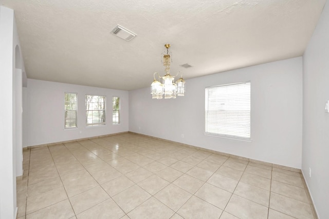 4310 Lucas Trace Ct, Houston, TX 77066 - spare room featuring a chandelier, light tile patterned floors, and baseboards