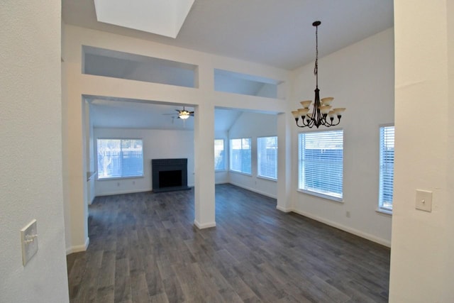 5326 Village Springs Dr, Houston, TX 77339 - unfurnished living room with vaulted ceiling, a fireplace with raised hearth, dark wood-type flooring, ceiling fan, and a chandelier