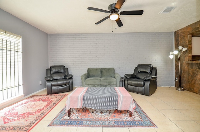 7373 Cook Rd, Houston, TX 77072 - living room featuring light tile patterned floors, a ceiling fan, and brick wall