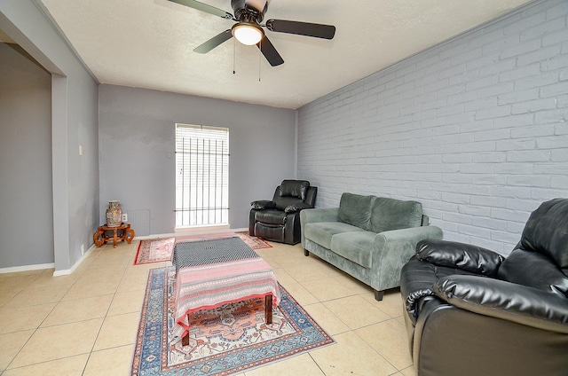7373 Cook Rd, Houston, TX 77072 - living area with brick wall, light tile patterned floors, ceiling fan, and baseboards