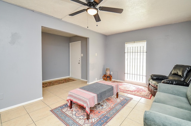 7373 Cook Rd, Houston, TX 77072 - living area with tile patterned floors, ceiling fan, and baseboards