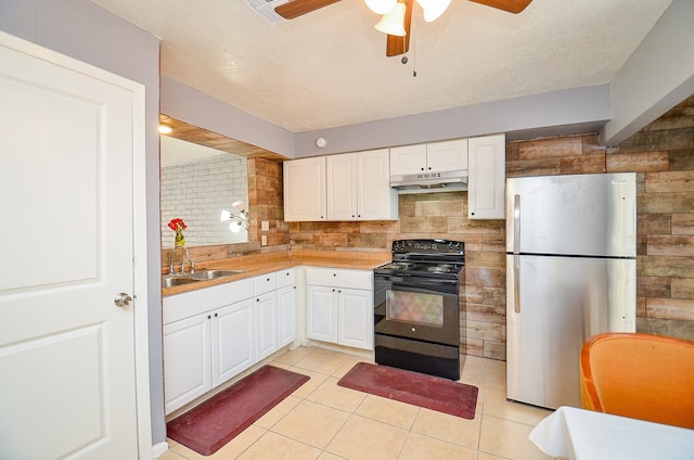 7373 Cook Rd, Houston, TX 77072 - kitchen with black electric range oven, freestanding refrigerator, a sink, under cabinet range hood, and light tile patterned floors