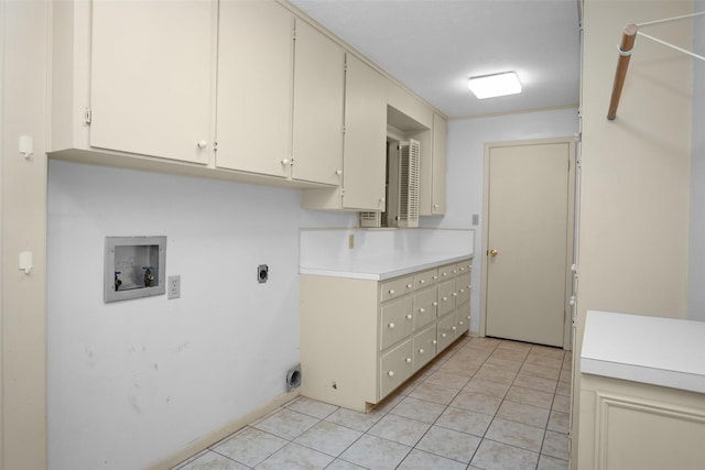 103 N Gordon Dr, Crockett, TX 75835 - laundry room featuring cabinet space, hookup for a washing machine, light tile patterned floors, and electric dryer hookup