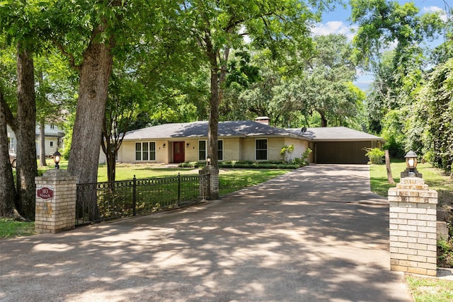 103 N Gordon Dr, Crockett, TX 75835 - ranch-style home featuring driveway, a chimney, an attached carport, and brick siding