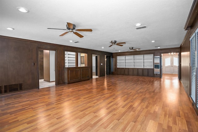 103 N Gordon Dr, Crockett, TX 75835 - unfurnished living room featuring ceiling fan, light wood-type flooring, recessed lighting, crown molding, and wooden walls