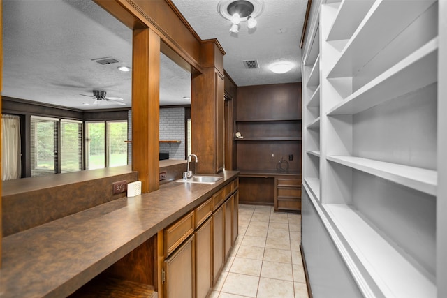 103 N Gordon Dr, Crockett, TX 75835 - bar area with a sink, a textured ceiling, a ceiling fan, and light tile patterned floors