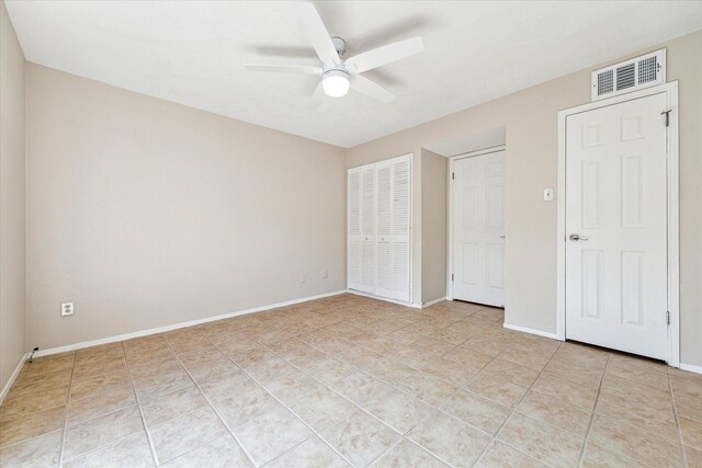 4631 Wild Indigo St Unit 575, Houston, TX 77027 - unfurnished bedroom featuring light tile patterned floors, a closet, and baseboards