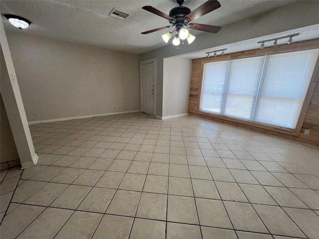 6402 Belarbor St, Houston, TX 77087 - spare room with a textured ceiling, ceiling fan, light tile patterned flooring, and baseboards