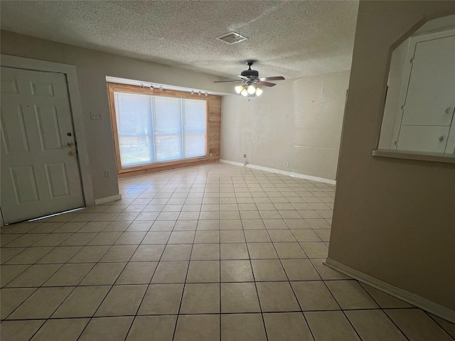 6402 Belarbor St, Houston, TX 77087 - spare room with baseboards, a ceiling fan, a textured ceiling, and light tile patterned floors