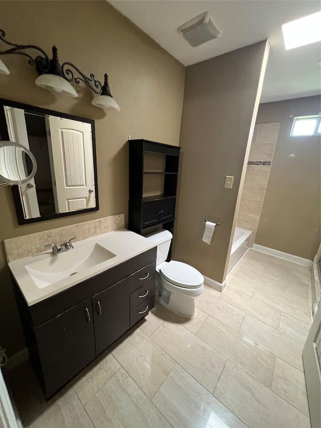 6402 Belarbor St, Houston, TX 77087 - bathroom with toilet, vanity, a shower, and backsplash