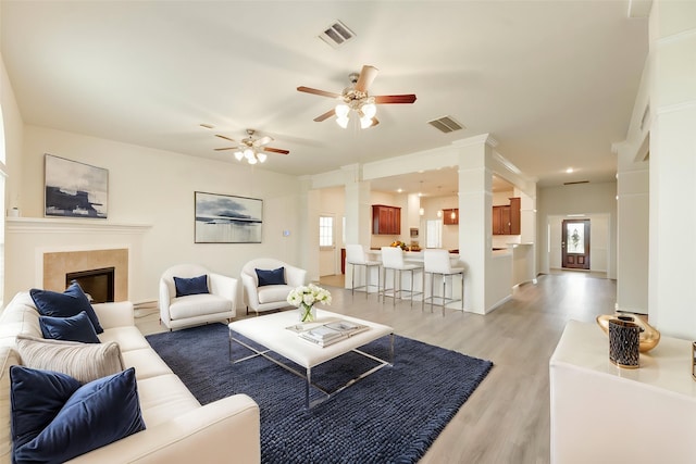 6751 Arlington Dr, Manvel, TX 77578 - living room with light wood-type flooring, ceiling fan, and a fireplace