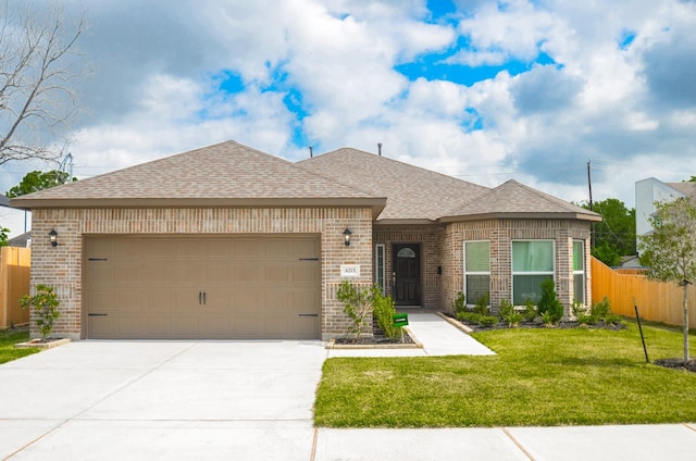 4215 Sterling St, Houston, TX 77051 - french country inspired facade with brick siding, a garage, driveway, and roof with shingles