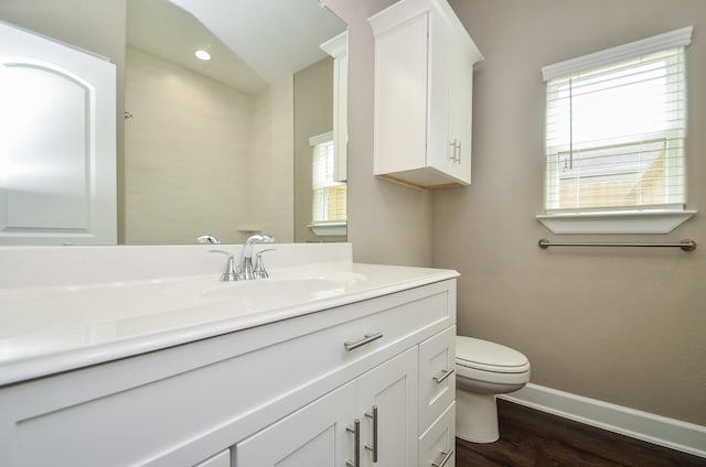 4215 Sterling St, Houston, TX 77051 - bathroom with baseboards, toilet, wood finished floors, and vanity