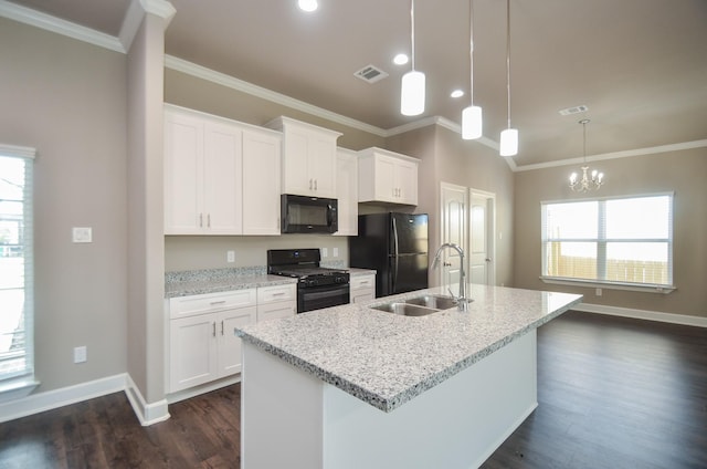 4215 Sterling St, Houston, TX 77051 - kitchen with black appliances, a sink, baseboards, dark wood-style floors, and a center island with sink