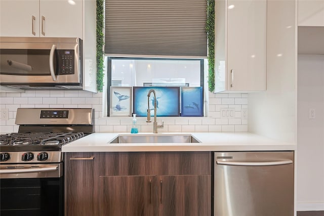 2317 Cleburne St, Houston, TX 77004 - kitchen featuring appliances with stainless steel finishes, a sink, modern cabinets, and decorative backsplash