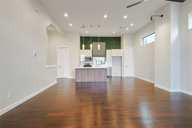 2317 Cleburne St, Houston, TX 77004 - living room with ceiling fan, recessed lighting, dark wood-style floors, and baseboards