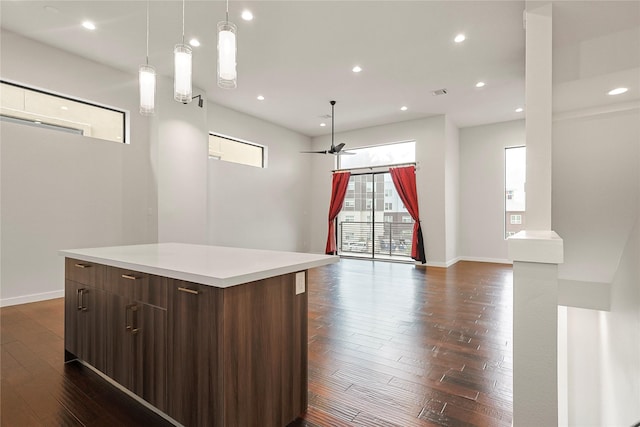 2317 Cleburne St, Houston, TX 77004 - kitchen with light countertops, dark wood-style floors, a kitchen island, modern cabinets, and recessed lighting