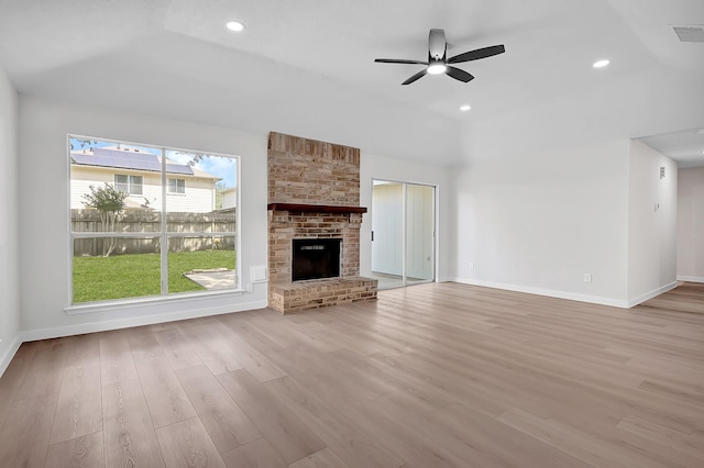 3246 Windmoor Dr, Katy, TX 77449 - unfurnished living room with wood finished floors, a ceiling fan, baseboards, a brick fireplace, and recessed lighting