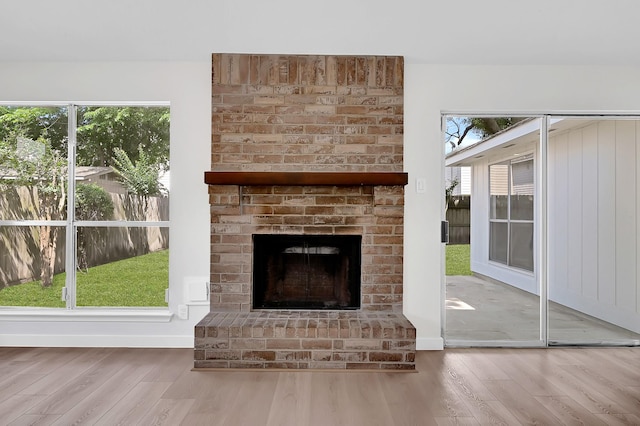 3246 Windmoor Dr, Katy, TX 77449 - detailed view of wood finished floors, a brick fireplace, and baseboards