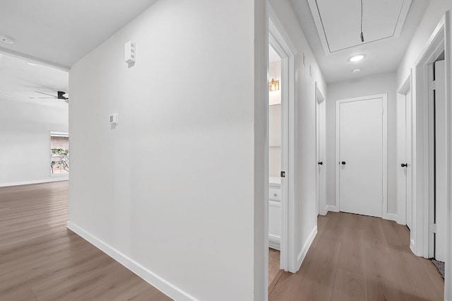 3246 Windmoor Dr, Katy, TX 77449 - corridor featuring attic access, light wood-type flooring, and baseboards
