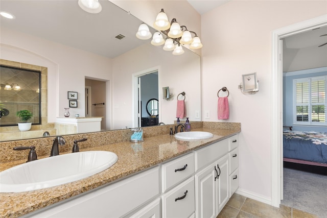 25019 Bahme Springs Ln, Porter, TX 77365 - ensuite bathroom featuring double vanity, tile patterned flooring, and baseboards