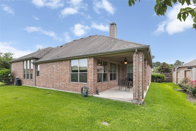25019 Bahme Springs Ln, Porter, TX 77365 - back of house with ceiling fan, brick siding, a patio area, a chimney, and roof with shingles