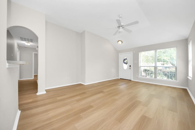 1805 Coronel St, Alvin, TX 77511 - unfurnished living room with light wood-style floors, a ceiling fan, baseboards, vaulted ceiling, and arched walkways