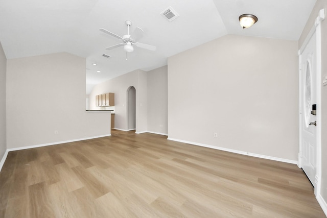 1805 Coronel St, Alvin, TX 77511 - unfurnished living room featuring lofted ceiling, a ceiling fan, arched walkways, light wood-type flooring, and baseboards