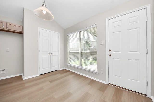 1805 Coronel St, Alvin, TX 77511 - foyer featuring light wood-style flooring, healthy amount of natural light, lofted ceiling, and baseboards