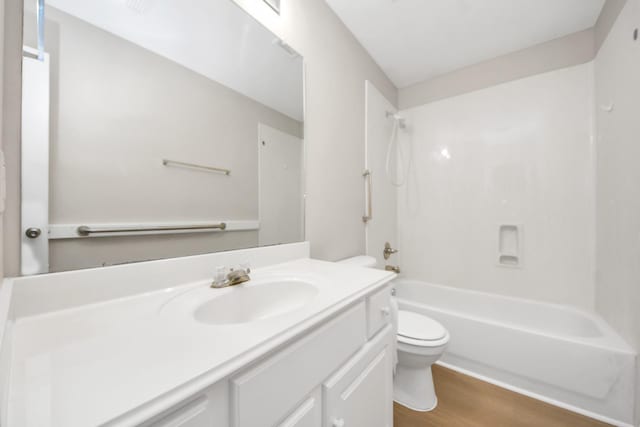1805 Coronel St, Alvin, TX 77511 - full bath with toilet, vanity, wood finished floors, and washtub / shower combination