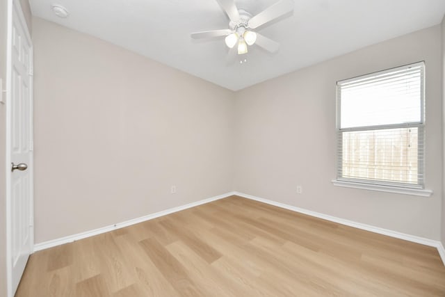 1805 Coronel St, Alvin, TX 77511 - spare room with light wood finished floors, baseboards, ceiling fan, and a smoke detector