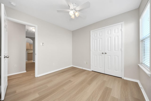 1805 Coronel St, Alvin, TX 77511 - unfurnished bedroom featuring light wood-style floors, multiple windows, and arched walkways