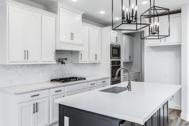 4131 Creek Shore Ln, Fulshear, TX 77441 - kitchen with appliances with stainless steel finishes, a sink, backsplash, a chandelier, and white cabinets