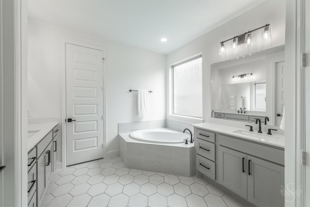 4131 Creek Shore Ln, Fulshear, TX 77441 - full bathroom featuring two vanities, a garden tub, tile patterned flooring, and recessed lighting
