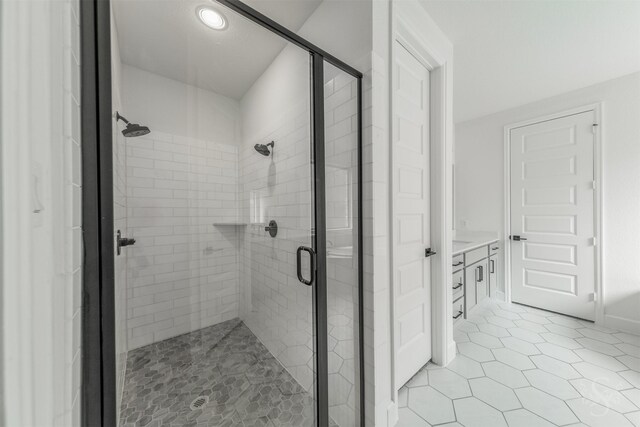 4131 Creek Shore Ln, Fulshear, TX 77441 - bathroom featuring a stall shower, vanity, tile patterned flooring, and recessed lighting