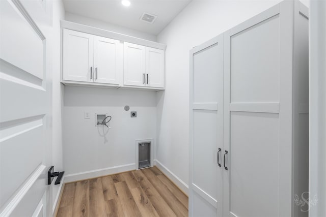 4131 Creek Shore Ln, Fulshear, TX 77441 - laundry area with hookup for an electric dryer, cabinet space, washer hookup, light wood-style floors, and baseboards