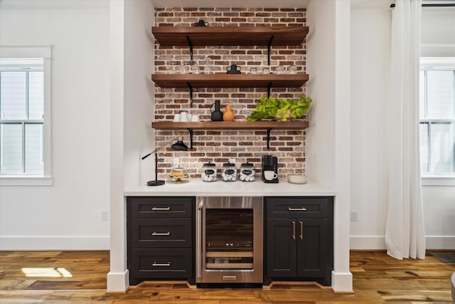 1514 31st St, Galveston, TX 77550 - indoor dry bar with beverage cooler, baseboards, and wood finished floors