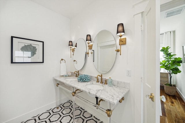 1514 31st St, Galveston, TX 77550 - bathroom featuring baseboards and double vanity