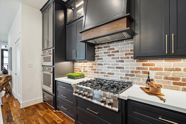 1514 31st St, Galveston, TX 77550 - kitchen with stainless steel gas cooktop, light countertops, dark wood finished floors, and baseboards