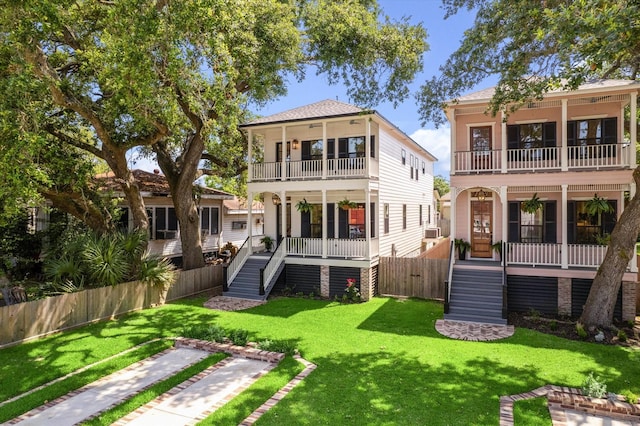1514 31st St, Galveston, TX 77550 - rear view of property with a balcony, covered porch, stairway, and cooling unit